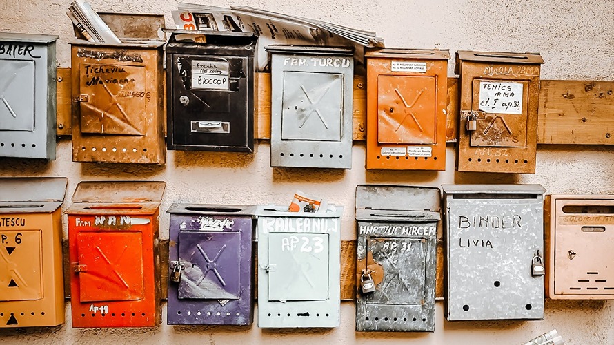 Wall-mounted mailboxes painted in different colors